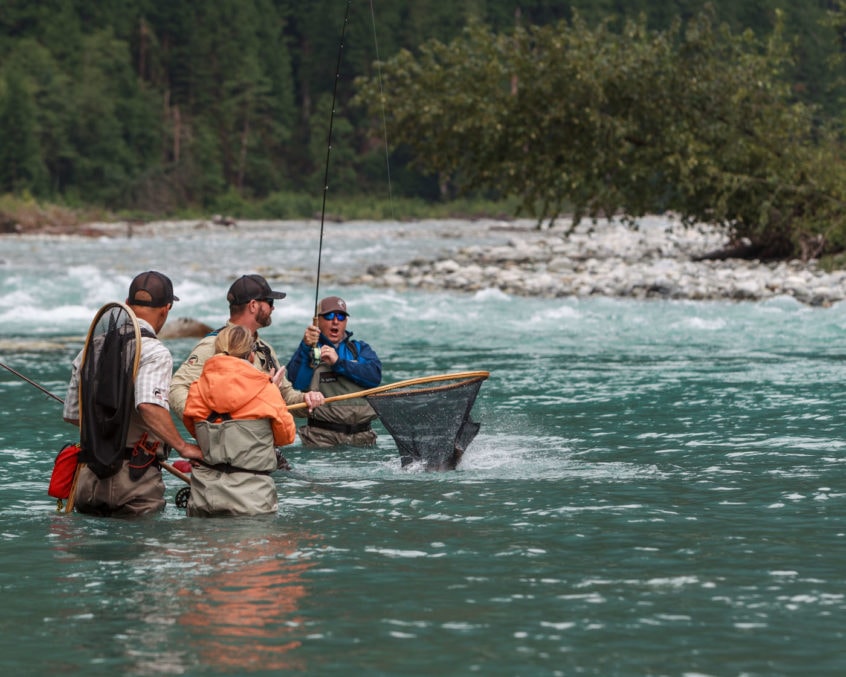Guide nets a bull trout near Whistler BC